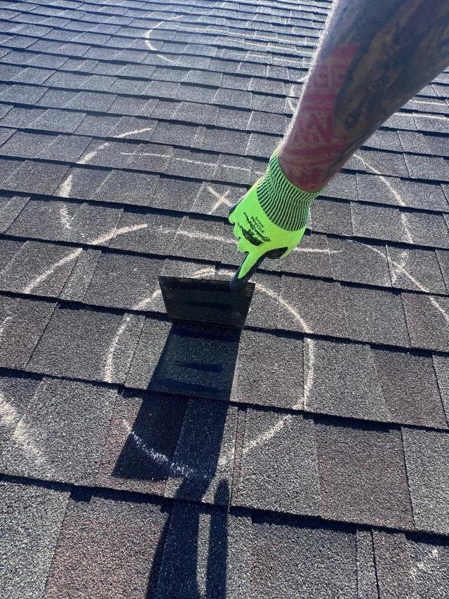 Roof damage marked with chalk during an inspection