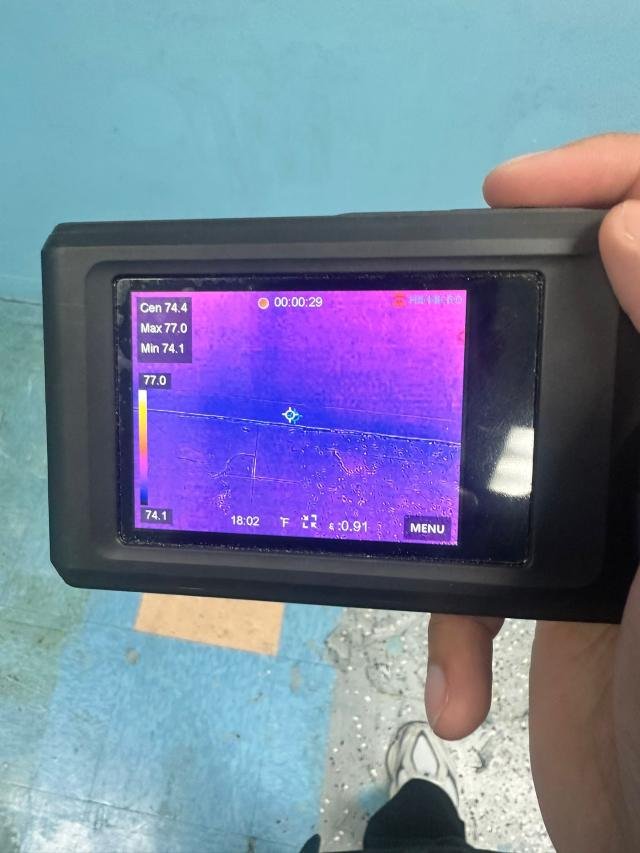 Thermal camera checking a wall for hidden moisture